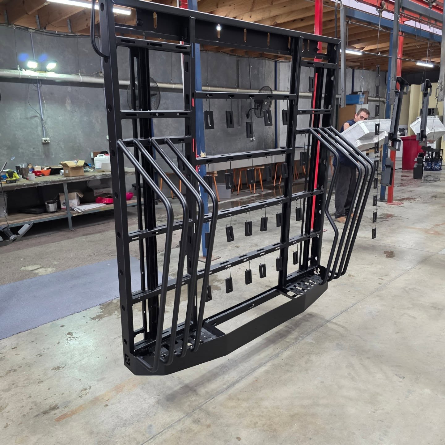 The same fabricated assembly after receiving a uniform black powder-coated finish