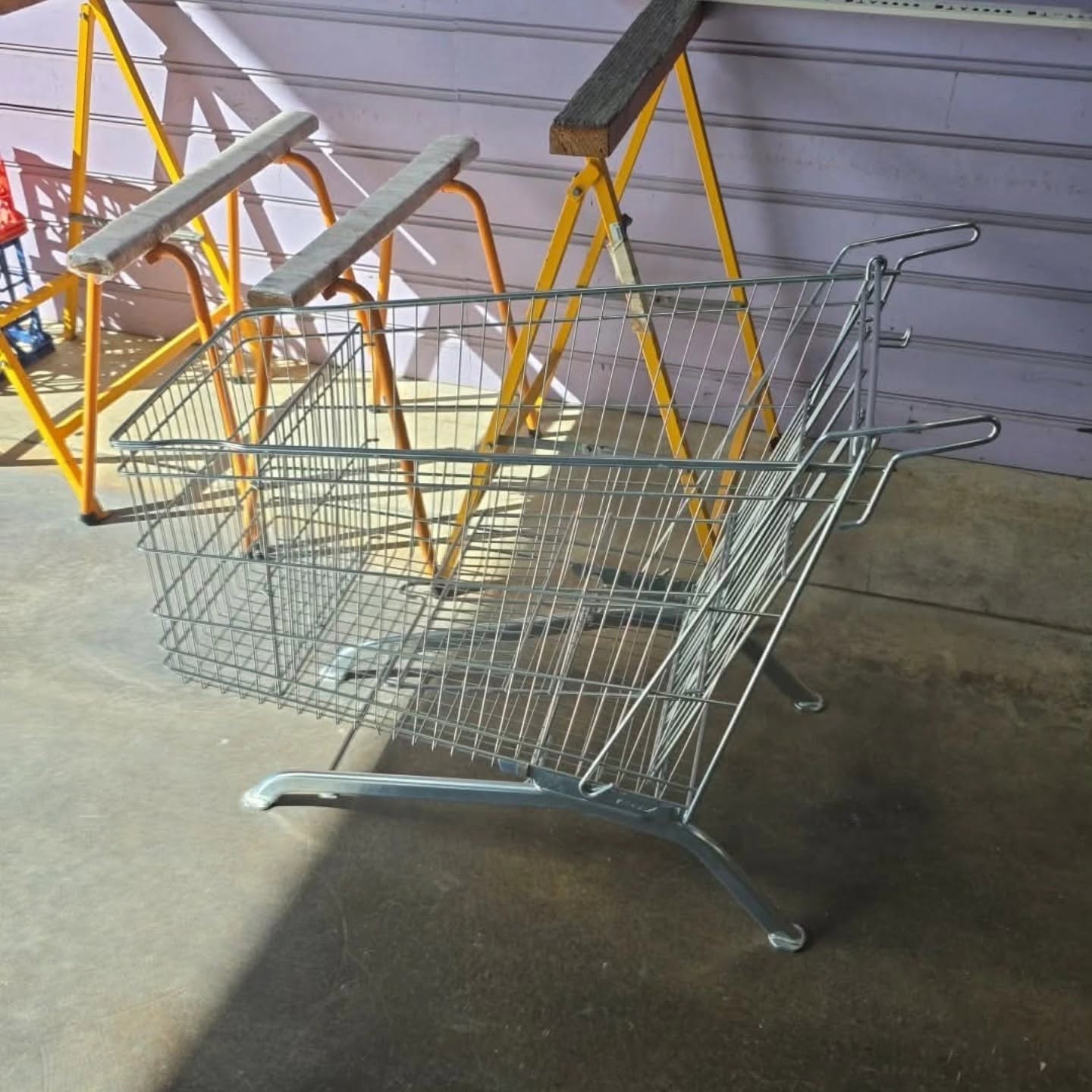 Uncoated metal shopping trolley before restoration