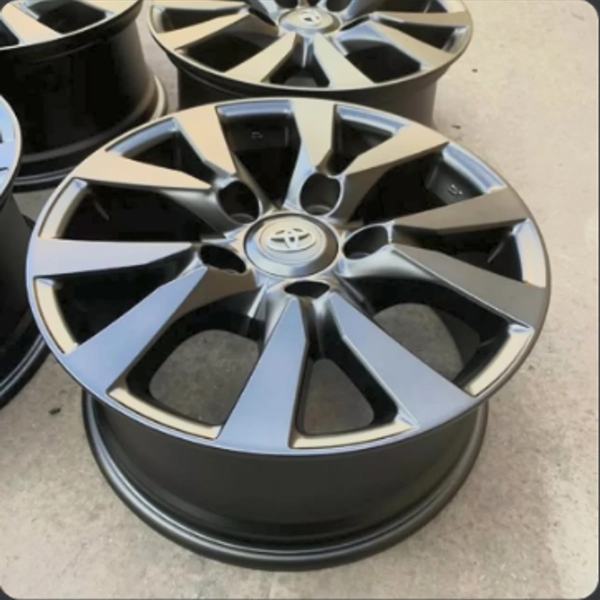 Freshly powder-coated automotive wheel with a black and machined finish